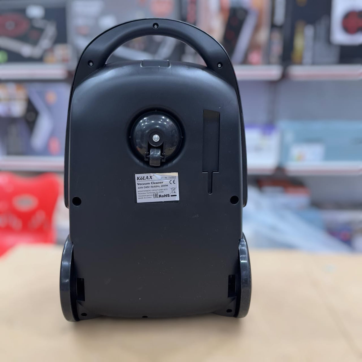 Kolax upright vacuum cleaner in use on carpet